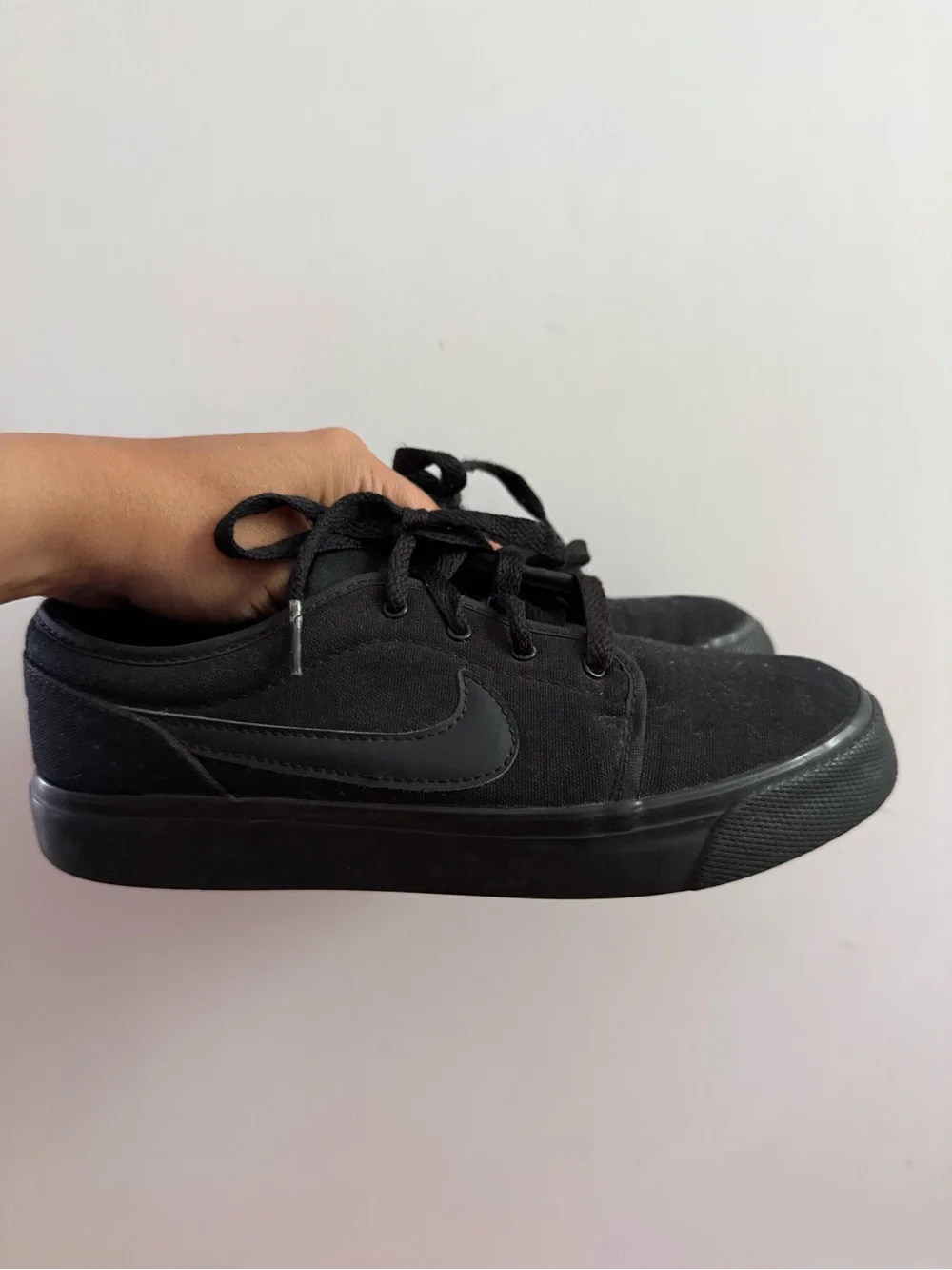 Nike Toki Low Triple Black canvas colorway (model number 555272-015) sneakers 4Y